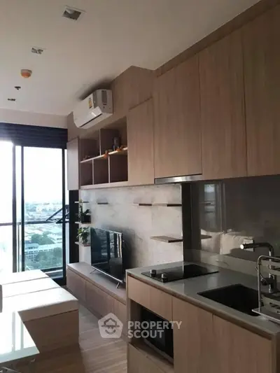 Modern kitchen with sleek cabinetry and integrated appliances in a stylish apartment.