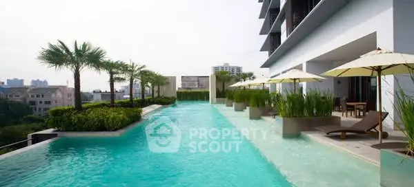 Luxurious rooftop pool with stunning city views and elegant lounging area.