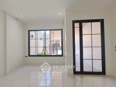 Bright and spacious living room with large windows and modern design