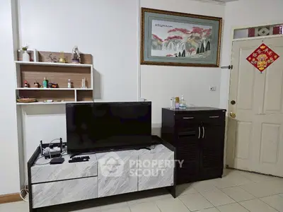 Cozy living room with modern TV stand and elegant wall art, perfect for relaxation.