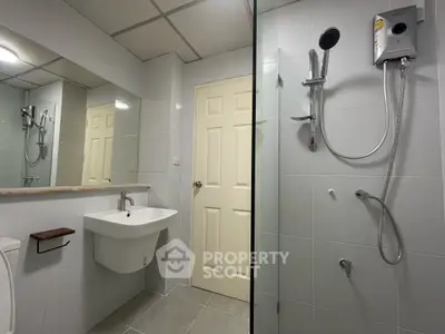 Modern bathroom with sleek fixtures and spacious shower area