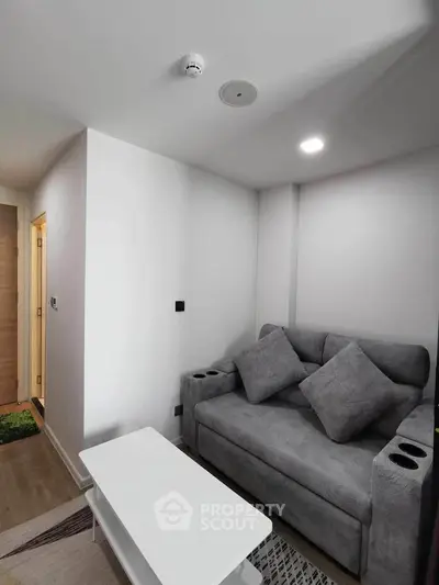 Cozy modern living room with gray sofa and sleek white coffee table