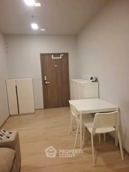 Cozy minimalist living space with wooden flooring and modern furniture, perfect for urban living.