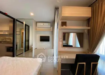 Modern bedroom with study area and open kitchen layout in a stylish apartment