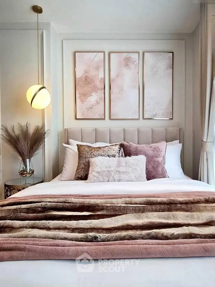 Luxurious bedroom with elegant decor and plush bedding, featuring modern lighting and stylish wall art.