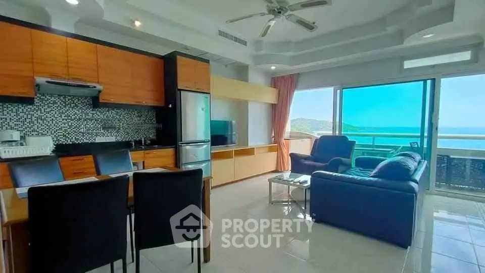 Spacious open-plan living room with ocean view balcony in modern apartment.