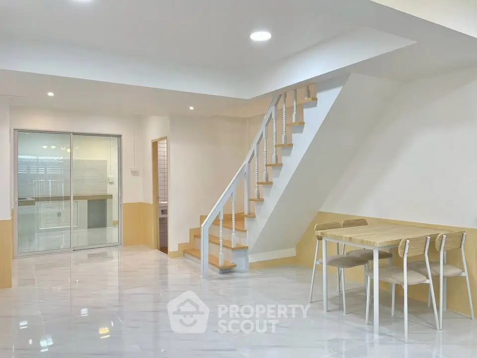 Spacious modern interior with staircase and dining area, perfect for family living.