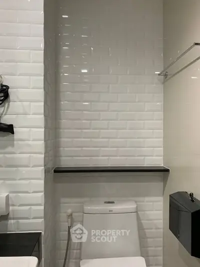 Modern bathroom with sleek white tiles and contemporary fixtures