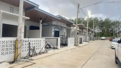 Modern residential street with contemporary single-story homes and clean, minimalist design.