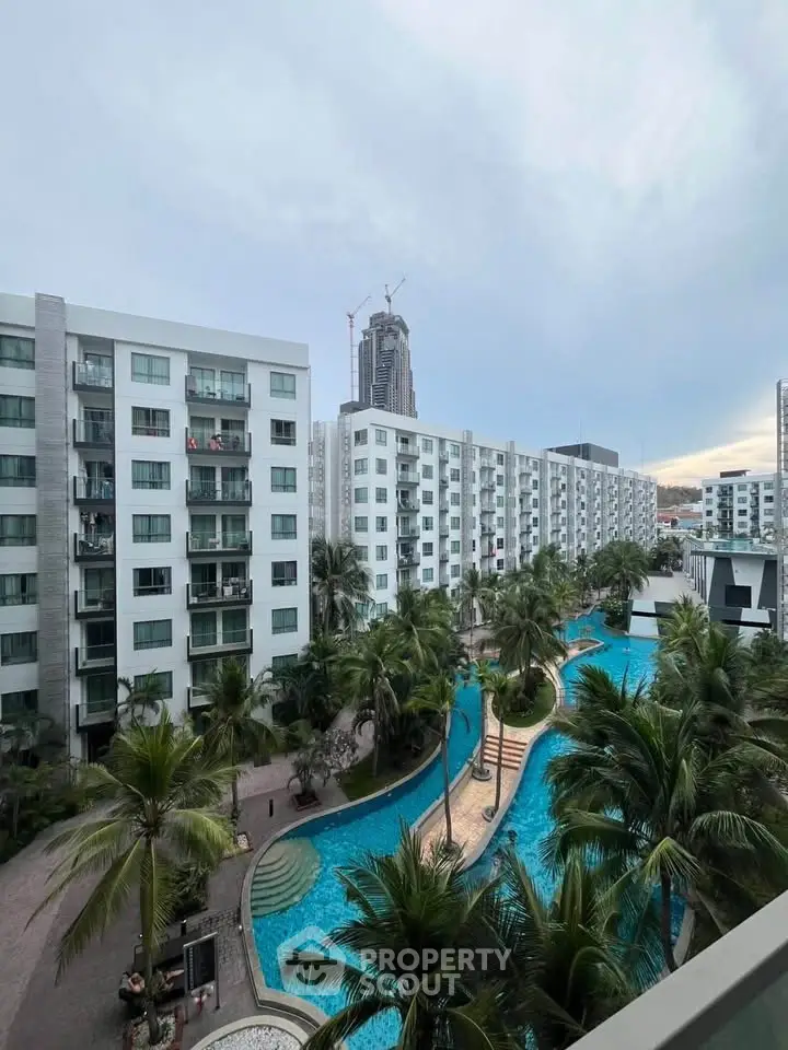Luxurious residential complex with stunning pool and modern architecture.