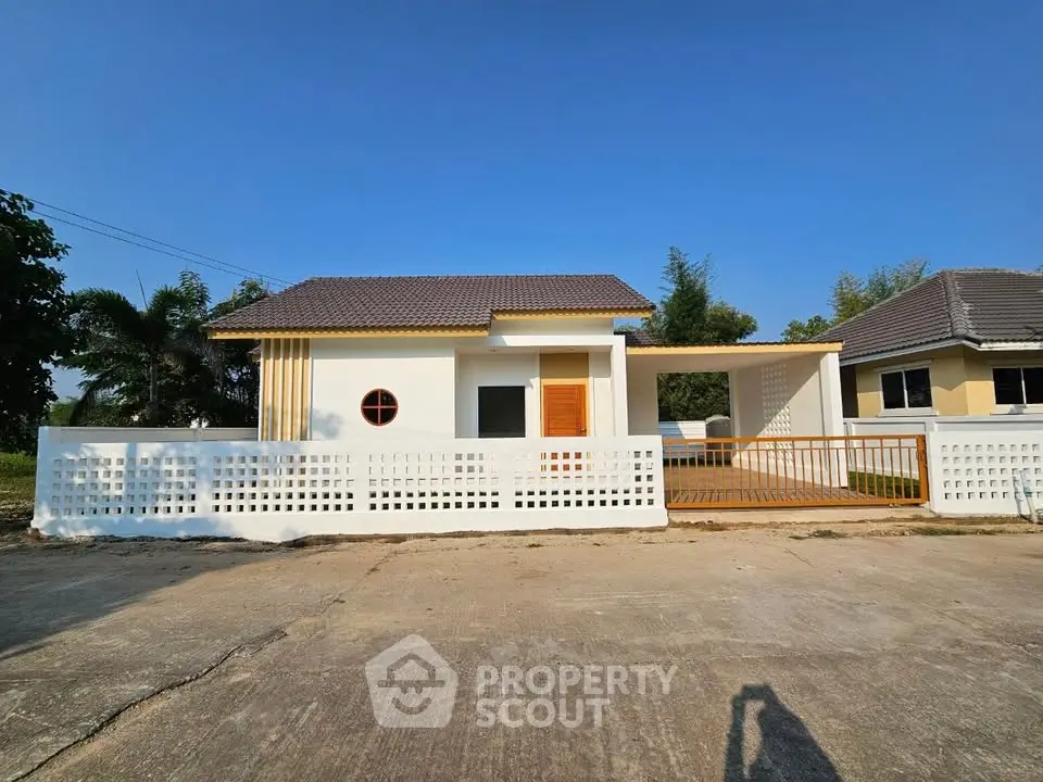 Charming single-story home with modern design and spacious driveway in serene neighborhood.