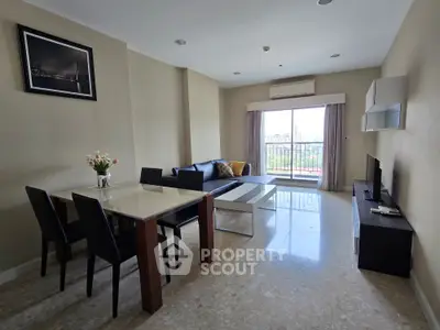 Spacious living room with modern furniture and large window offering a scenic view, perfect for relaxation.