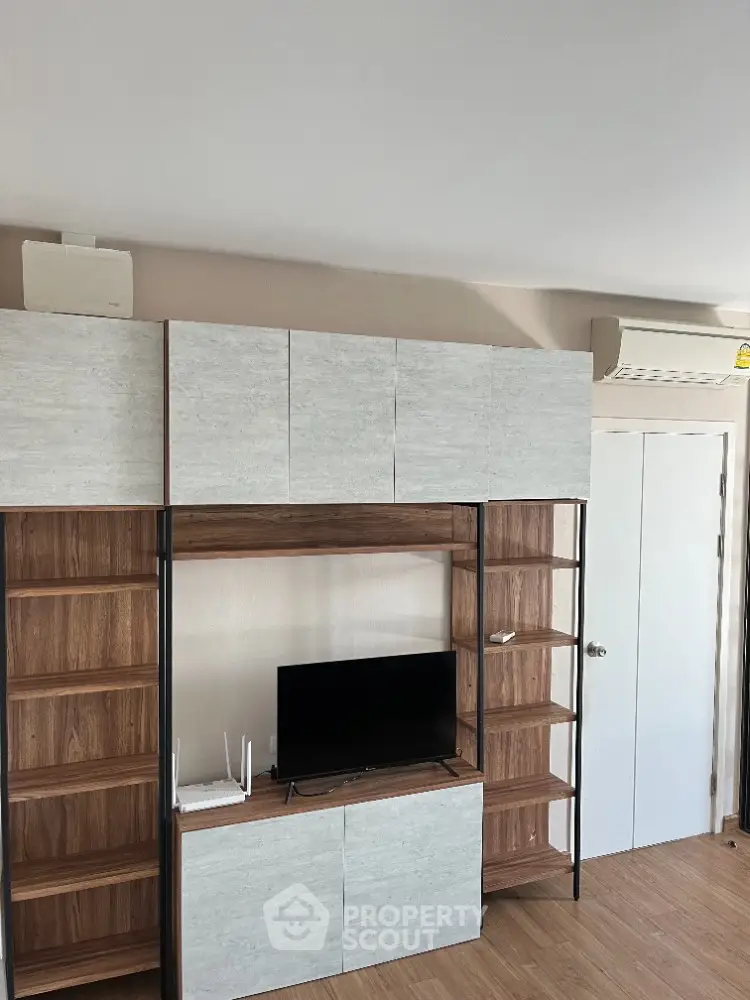 Modern living room with stylish TV cabinet and air conditioning