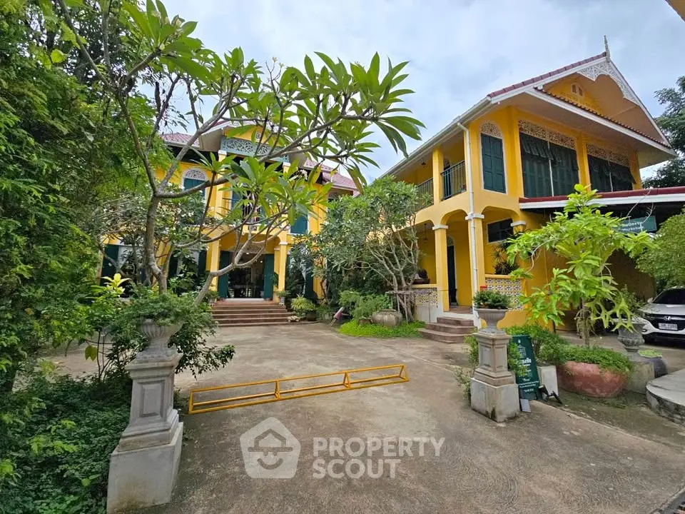 Charming yellow villa with lush garden and spacious driveway
