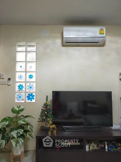 Cozy living room with air conditioning and modern TV setup