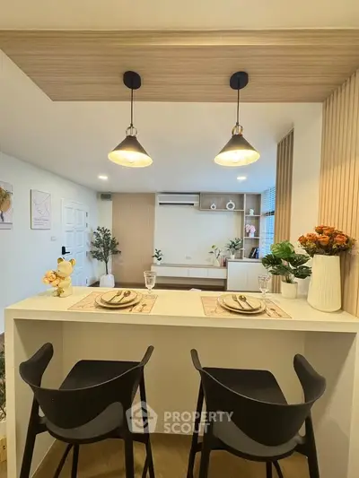 Modern living room with stylish bar seating and elegant lighting