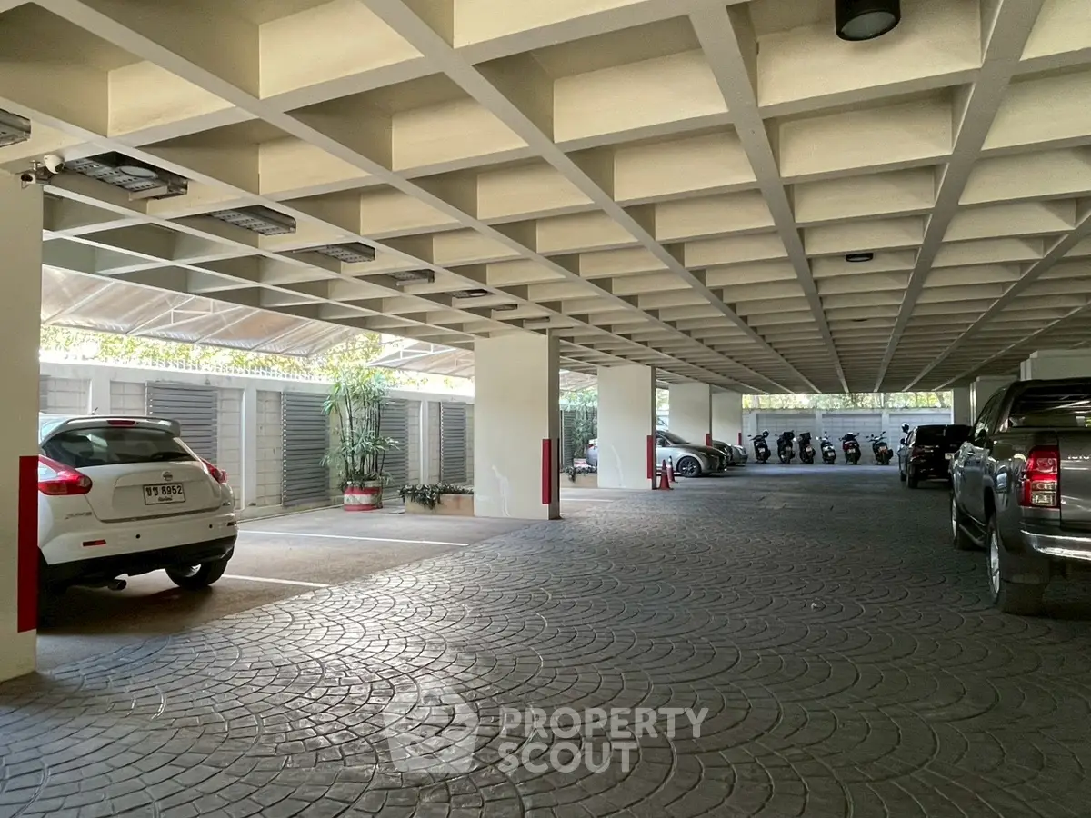 Spacious covered parking area with modern design and ample vehicle space.