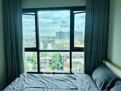 Stunning bedroom with panoramic city view from high-rise window, featuring modern decor and cozy ambiance.