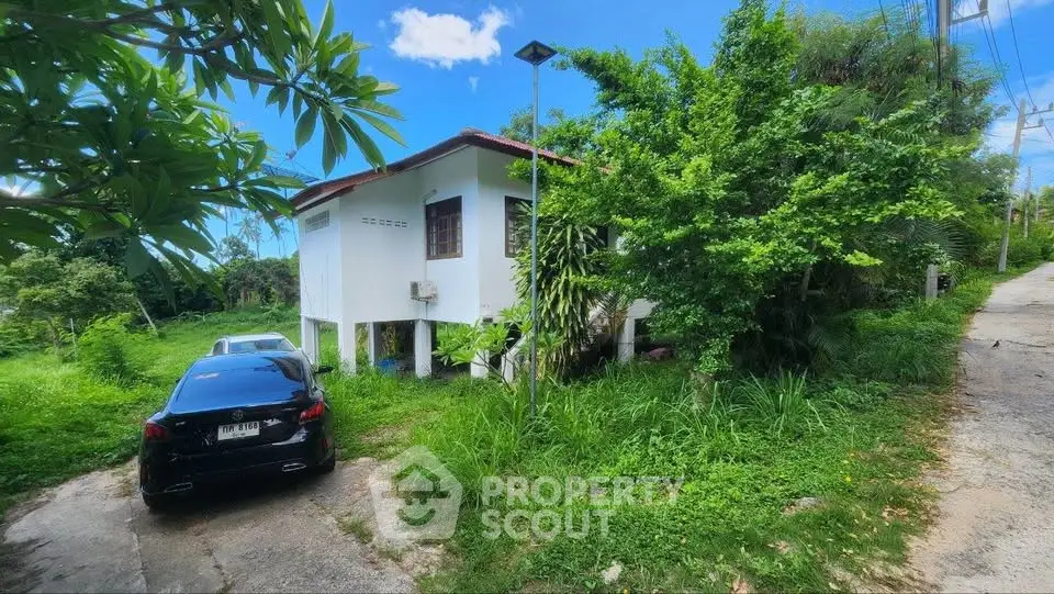 Charming countryside house with lush greenery and private driveway, perfect for serene living.