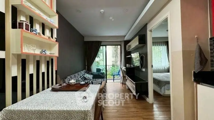 Modern apartment interior with open living and dining area, stylish decor, and balcony view.
