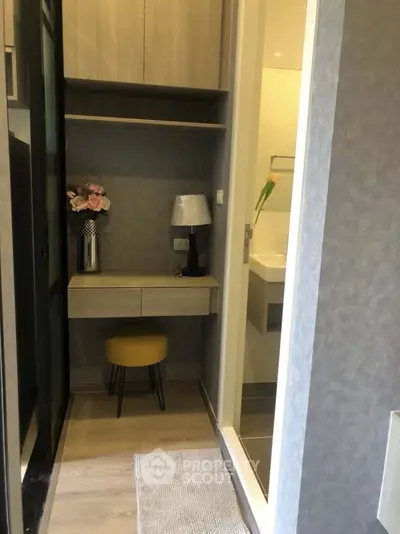 Chic compact study nook with modern decor and ambient lighting, perfect for small spaces.