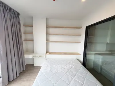 Modern bedroom with built-in shelves and large window for natural light