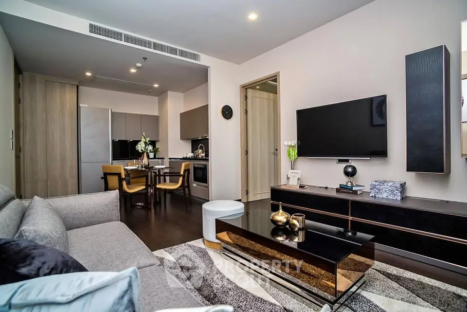 Modern living room with open kitchen, stylish decor, and cozy seating area in a contemporary apartment.