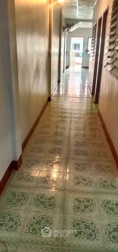 Bright corridor with tiled flooring in residential building