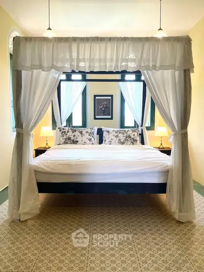 Charming bedroom with canopy bed and elegant decor, perfect for a cozy retreat.