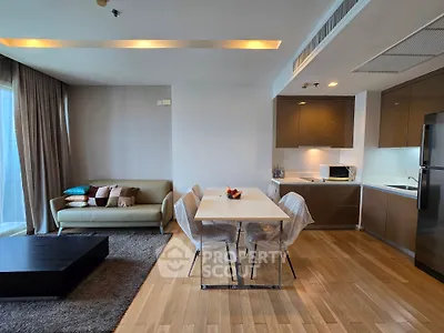 Modern open-plan living room and kitchen with sleek design and cozy ambiance.