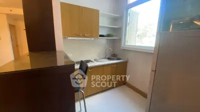 Cozy kitchen with wooden cabinets and breakfast bar in bright apartment