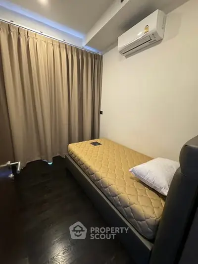 Cozy small bedroom with single bed and air conditioning
