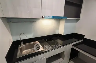 Modern kitchen with sleek black countertops and electric cooktop