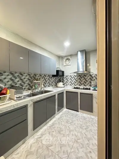 Modern kitchen with sleek cabinets and gas stove in stylish apartment