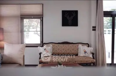 Charming living room with vintage sofa and elegant decor, perfect for cozy gatherings.