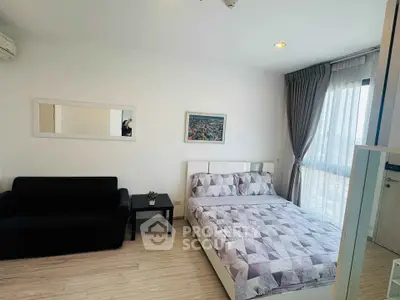 Modern bedroom with stylish decor and city view, featuring a cozy bed and elegant furnishings.