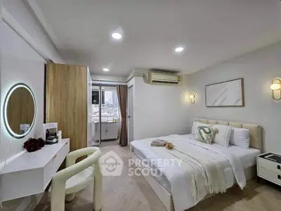 Modern bedroom with stylish decor and city view, featuring a cozy bed and elegant furniture.