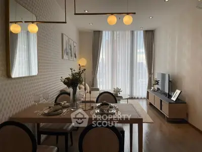 Elegant living room with dining area, modern decor, and large windows for natural light.