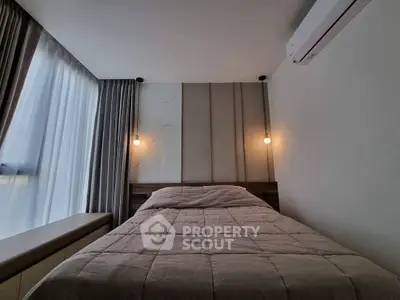 Modern bedroom with cozy lighting and stylish decor, featuring a comfortable bed and elegant curtains.