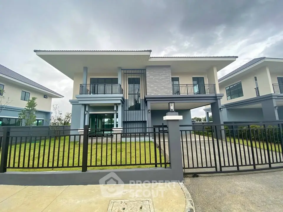 Modern two-story house with sleek design and spacious front yard