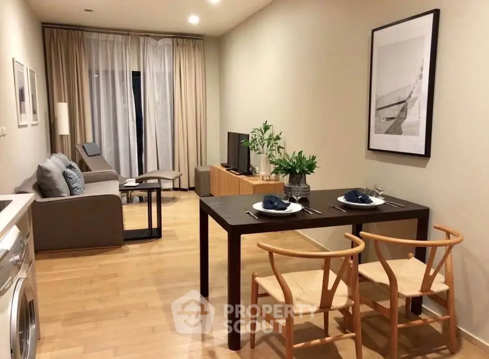 Modern living room with dining area, stylish furniture, and wooden flooring in a cozy apartment.