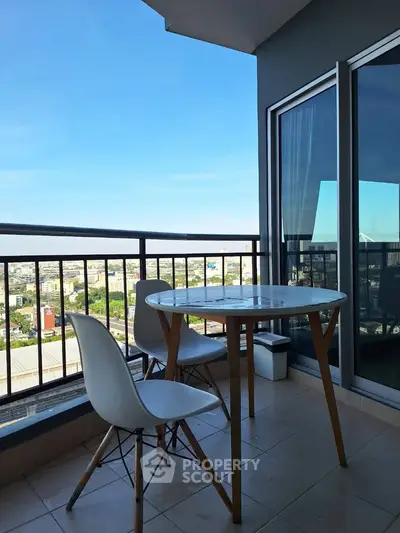 Chic balcony with modern furniture and stunning city view, perfect for relaxation and enjoying the skyline.