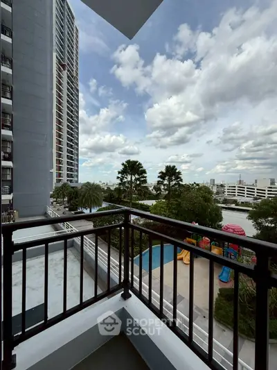 Spacious balcony with stunning city view and lush greenery