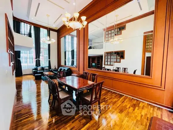 Luxurious dining area with high ceilings and elegant wooden finishes in a spacious living room.