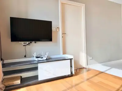Modern living room with wall-mounted TV and sleek furniture