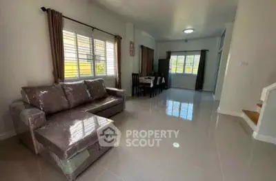 Spacious living room with modern furniture and large windows for natural light.