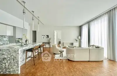 Luxurious open-plan living room with elegant marble kitchen island and modern decor.