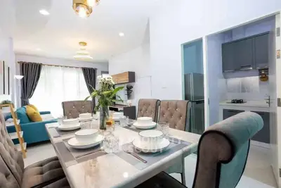 Modern open-plan dining and living area with elegant decor and a sleek kitchen.