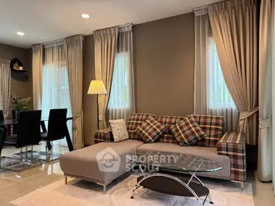 Elegant living room with stylish plaid sofa and modern glass coffee table, perfect for cozy gatherings.