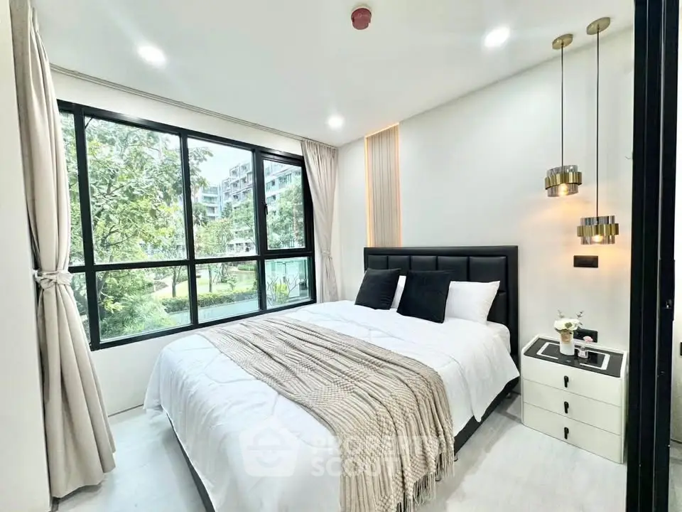 Modern bedroom with large window and stylish decor in a luxury apartment